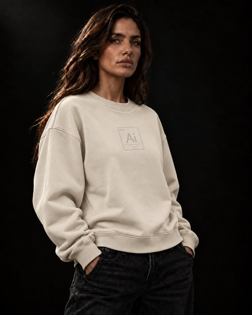 Model wearing the Possibility Crewneck in cream, oversized heavyweight fit, with the tone-on-tone embroidered Ai element tile, dark studio