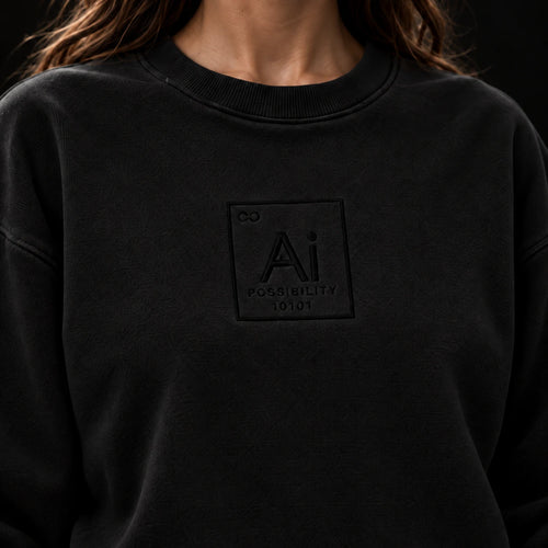 Close-up of the tone-on-tone Ai element mark on the chest of the washed black crewneck