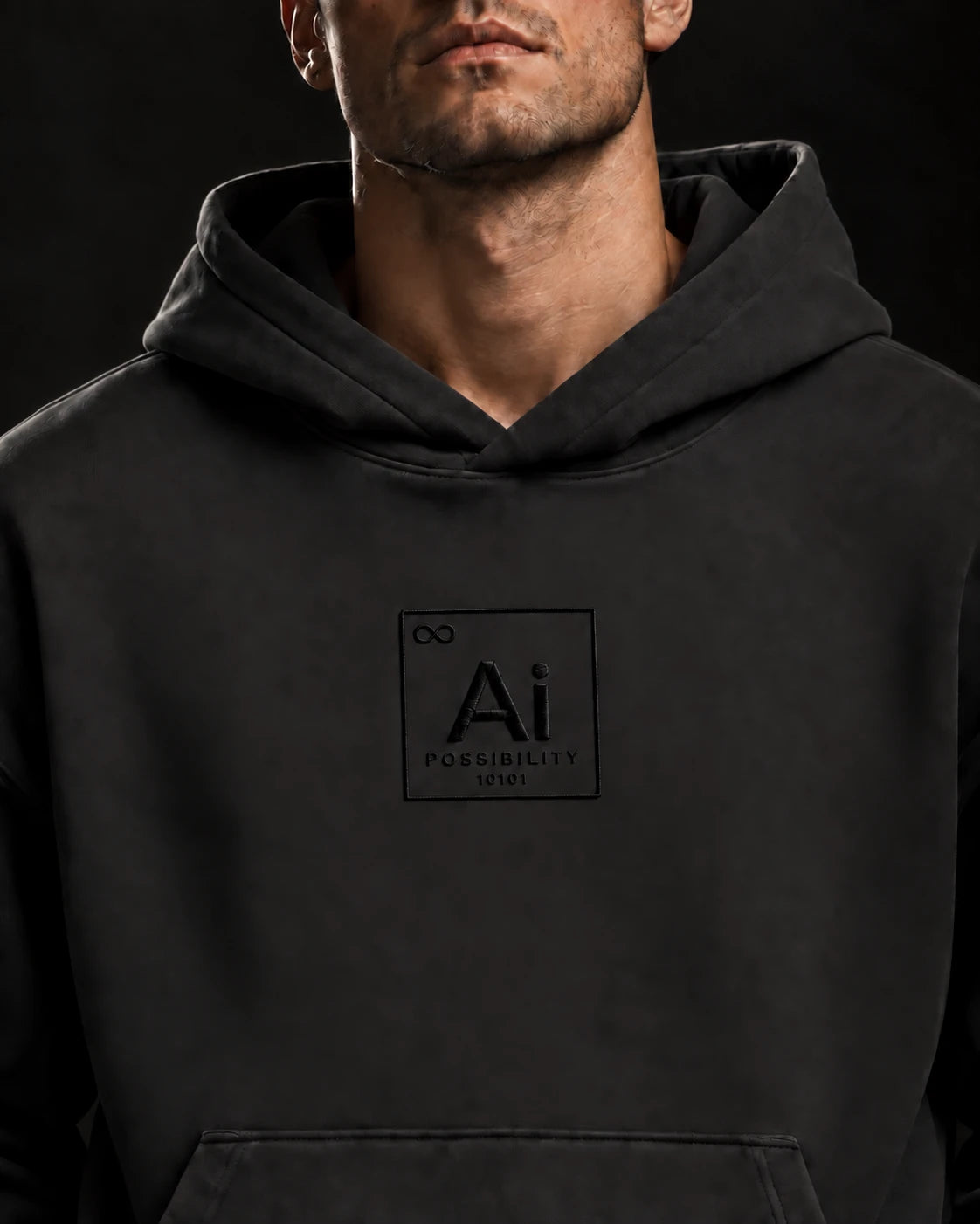 Close-up of the tone-on-tone Ai element mark with Possibility and 10101 on the washed black Possibility Hoodie