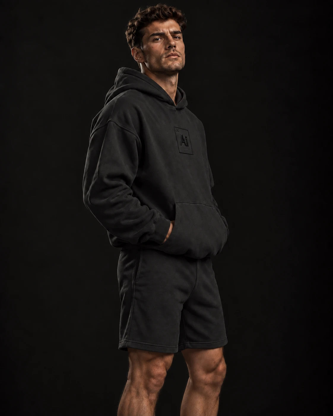 Side view of the Possibility Hoodie in washed black, oversized fit